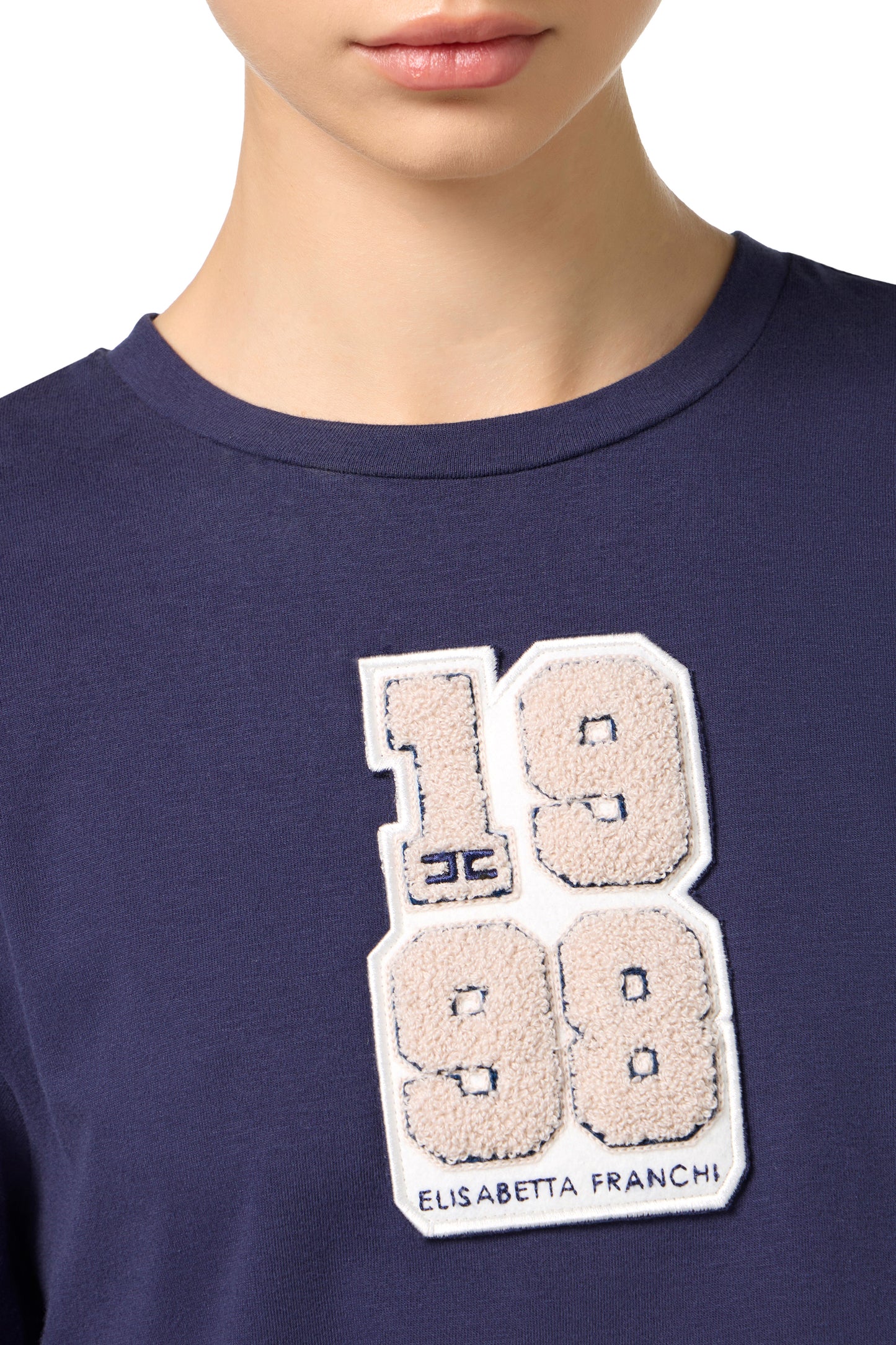 T-shirt with college-style logo patch