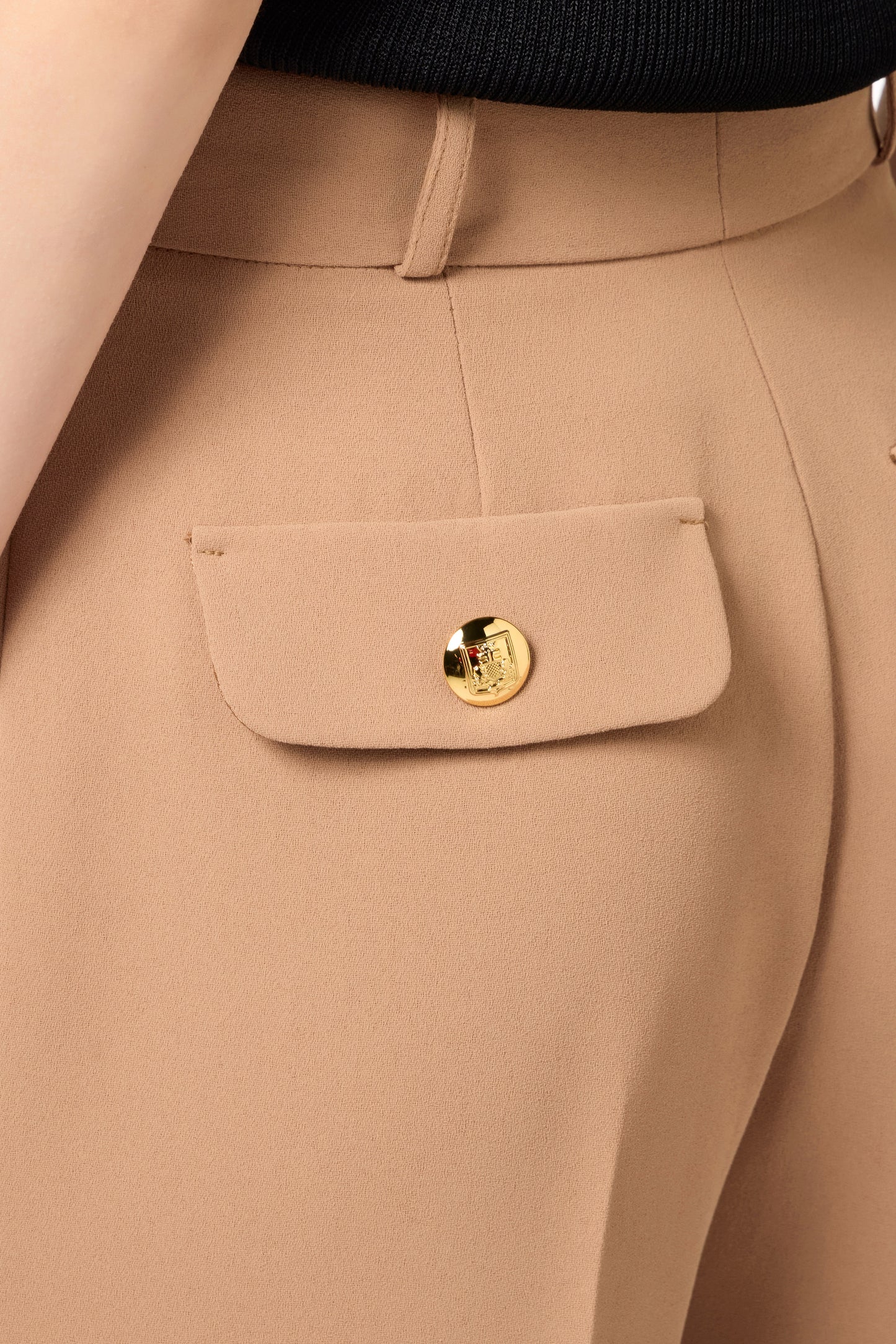 Straight trousers in woven crêpe fabric with emblem rivet