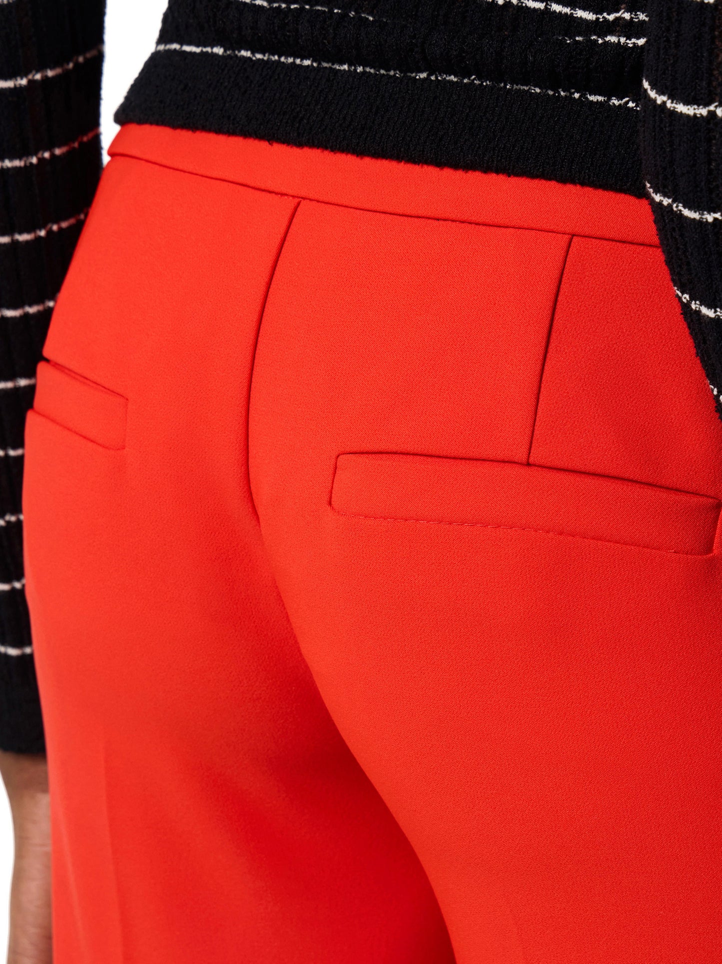Trousers in lightweight crêpe fabric with raw-edge trims