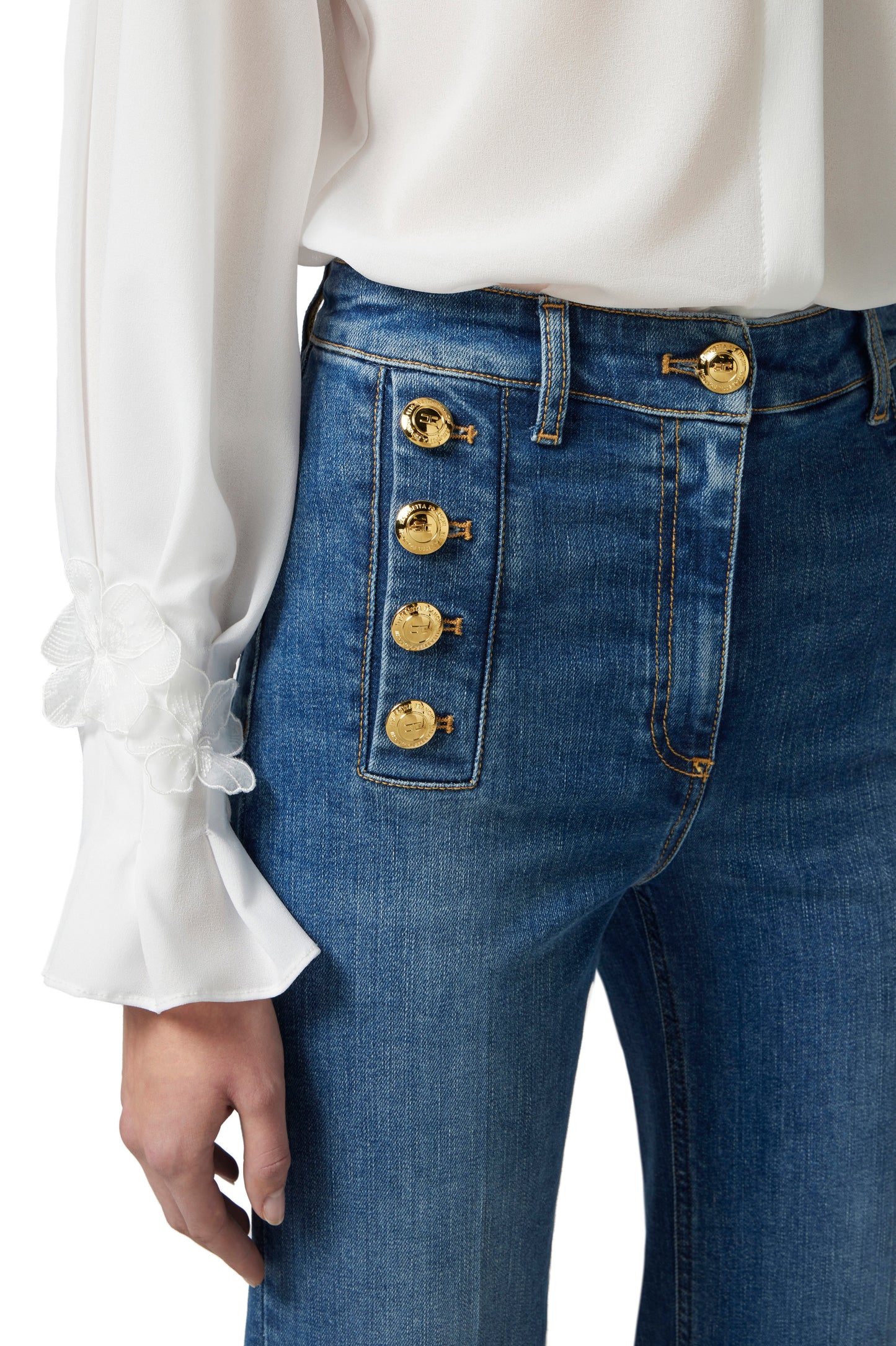 Bell-bottom jeans with row of buttons